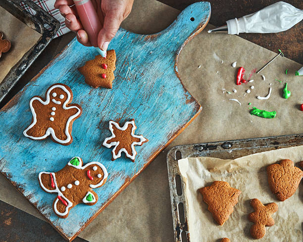istock Decorating Gingerbread Christmas Cookies with Icing 2242217235