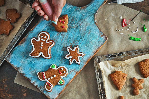 istock Decorating Gingerbread Christmas Cookies with Icing 2242217276