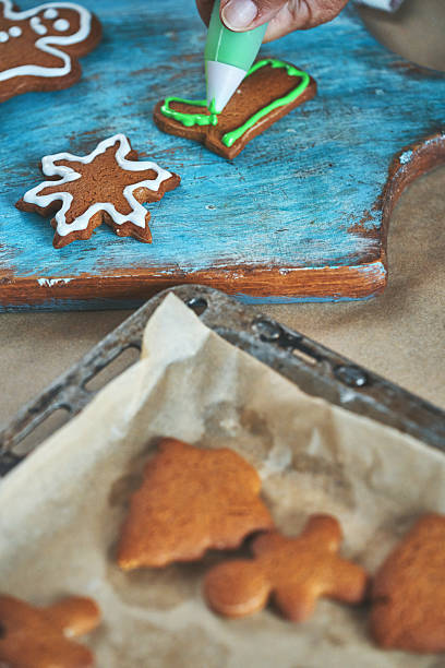 istock Decorating Gingerbread Christmas Cookies with Icing 2242219625