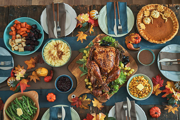 istock Having Stuffed Turkey for Thanksgiving Holiday Dinner with Vegetables and Gravy 2242221008