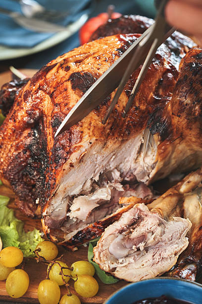 istock Having Stuffed Turkey for Thanksgiving Holiday Dinner with Vegetables and Gravy 2242221107