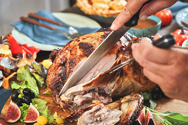 istock Having Stuffed Turkey for Thanksgiving Holiday Dinner with Vegetables and Gravy 2242221128