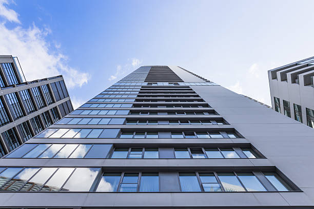 istock Modern glass skyscraper from below against blue sky, contemporary urban architecture 2242224678