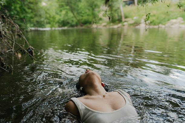 Photo of a beautiful Asian woman swimming in the river