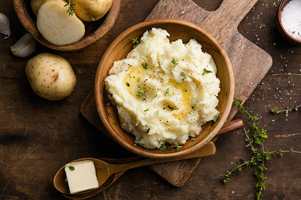 istock Mushed potatoes top view with raw potatoes and spices 2242227416