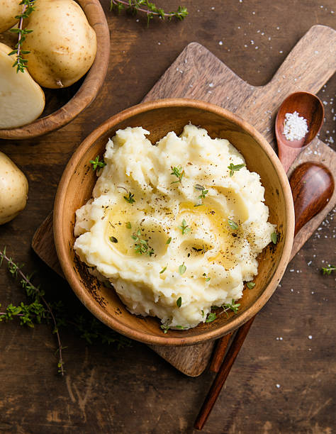 istock Mushed potatoes top view with raw potatoes and spices 2242227425