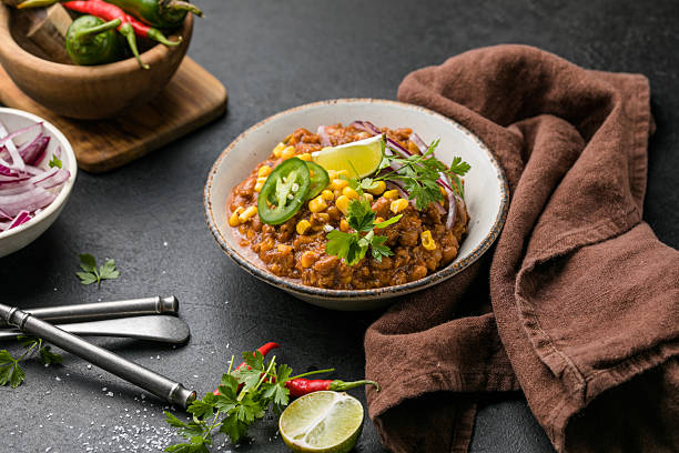 istock Chili con carne on wooden table with corn and spices 2242227454