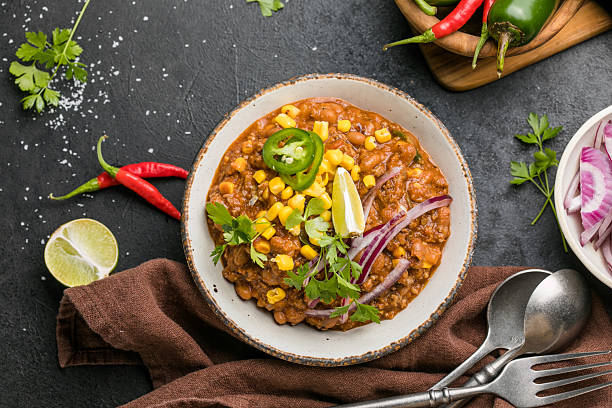 istock Chili con carne on wooden table with corn and spices 2242227460