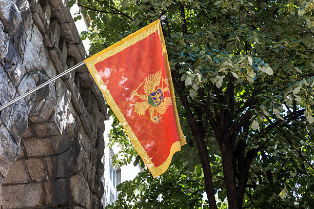 istock Montenegro red red a golden eagle emblem hangs near a textured stone wall 2242227581