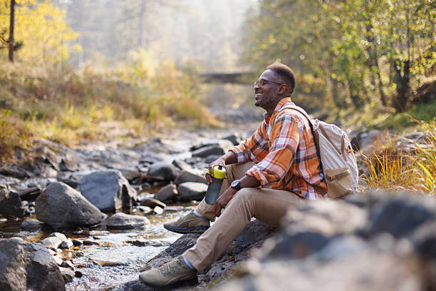 istock Man resting by a river in the forest 2242230976