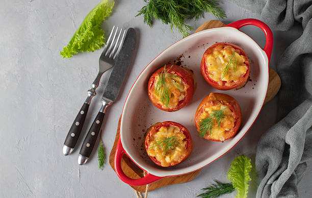 istock Baked stuffed tomatoes with chicken and cheese on light gray background 2242232338