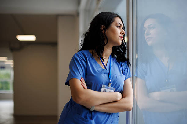 istock Exhausted nurse or doctor finishing her shift 2242235416