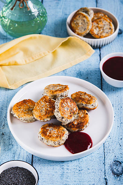 istock Small cottage cheese pancakes with poppy seeds on a plate on the table vertical view 2242236247