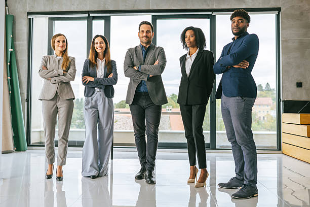 istock Diverse business team standing together in modern office 2242238514