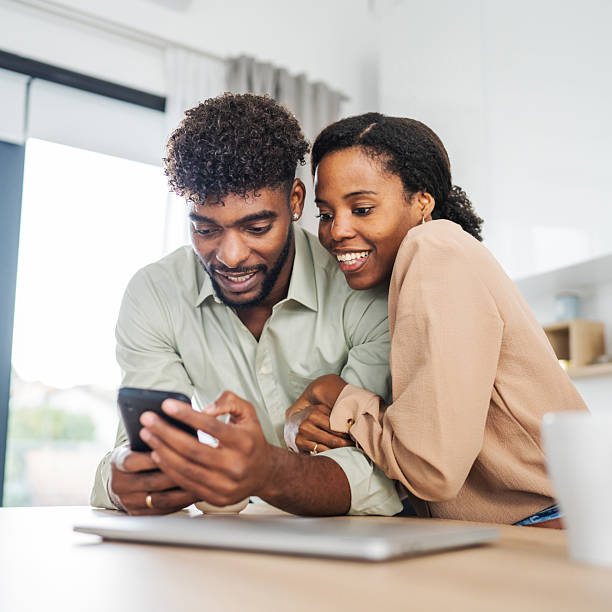 istock African american couple using mobile phone in kitchen 2242240454