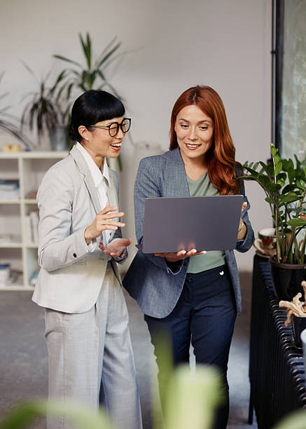 istock Professional Meeting Between Two Women in an Office Corridor 2242246911