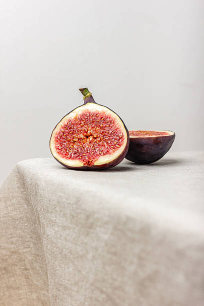 Fresh cut figs on a light background.