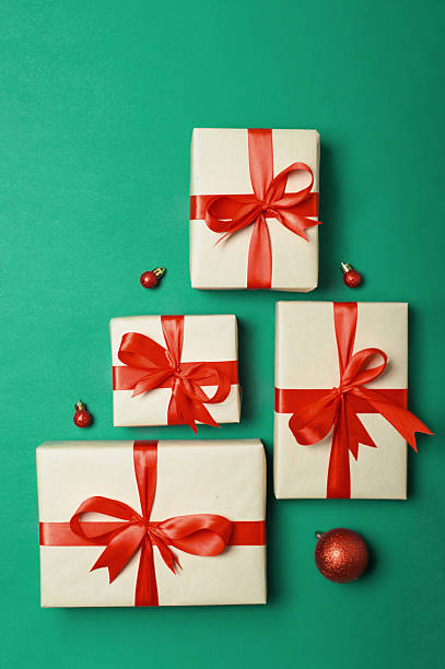 istock Christmas Gift Boxes Arranged in Tree Shape on Green Background 2242250071