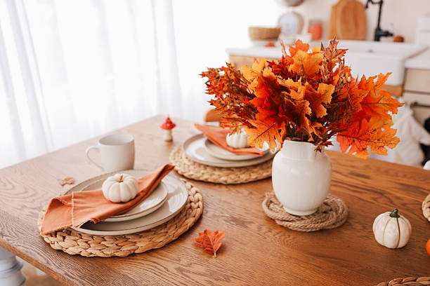istock Cozy autumn dining table setting with seasonal decorations and warm colors 2242250209