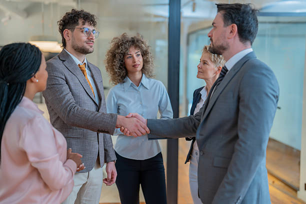 istock Business people shaking hands in modern office 2242269929