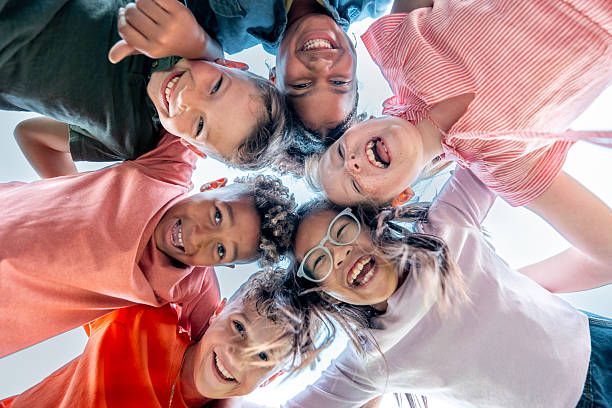 istock Happy Group Of Diverse Children In A Circle Looking Down At The Camera 2242270233