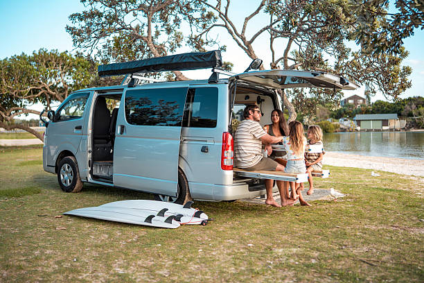 istock Young Family Dining Outdoors in Camper Van Picnic Scene 2242270704