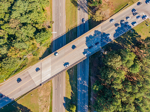 istock Aerial Drone Image of a Highway Junction Featuring An Overpass and Moderate Traffic on a Sunny Afternoon. 2242272037