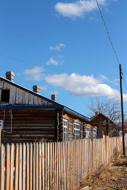 istock Rustic wooden house with fence under clear blue sky 2242276865