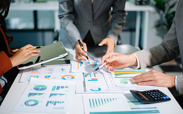 istock Business documents on office table with smart phone and calculator digital tablet and graph business with social network diagram 2242281285