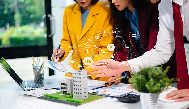 istock Professionals for a greener future. Showcasing renewable energy solutions with solar panels, wind turbines, and a model house. 2242281345