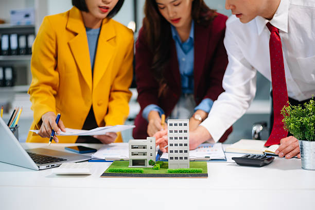 istock Professionals for a greener future. Showcasing renewable energy solutions with solar panels, wind turbines, and a model house. 2242281355