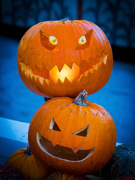 istock Stacked Jack-o’-Lanterns Glowing in Autumn Night for Halloween Celebration 2242282762