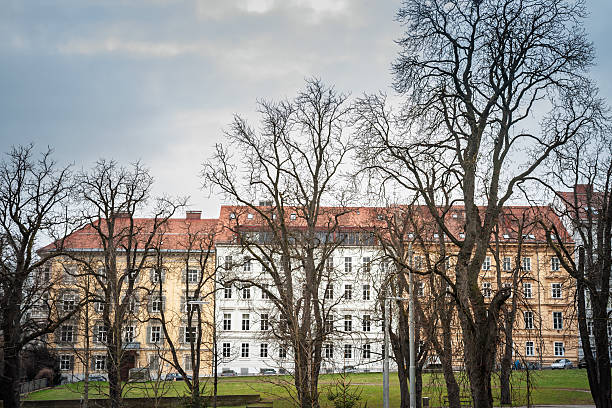 istock Residential facades facing a park in Graz with leafless trees, classic architecture and red roofs, depicting the housing environment and green space relationship in an Austrian city neighborhood. 2242283692