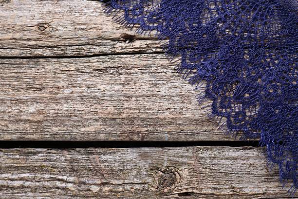 Beautiful lace on wooden table, top view. Space for text