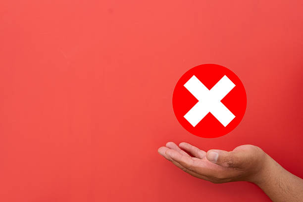 istock Rejection and Failure Concept. Hand holding a red X-mark (error) icon. 2242288874