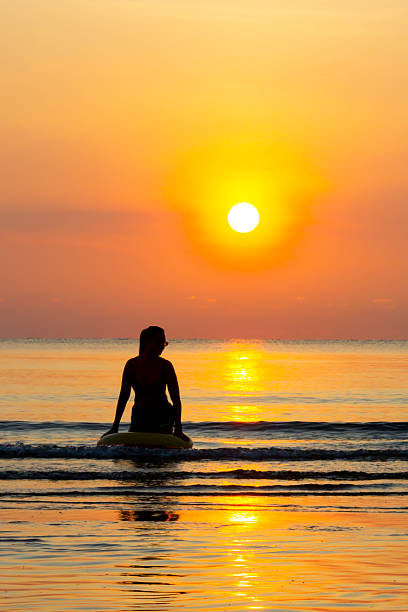 istock Woman with sunrise and silhouette 2242289804