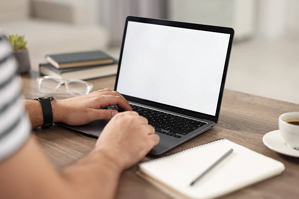 istock Young man watching webinar at table in room, closeup 2242290408