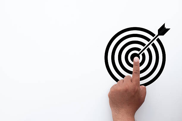 istock Business Goal and Target Objective Concept. Hand pointing to the bullseye. 2242290522