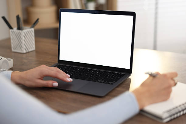 istock Young woman writing down notes during webinar at table indoors, closeup 2242290605