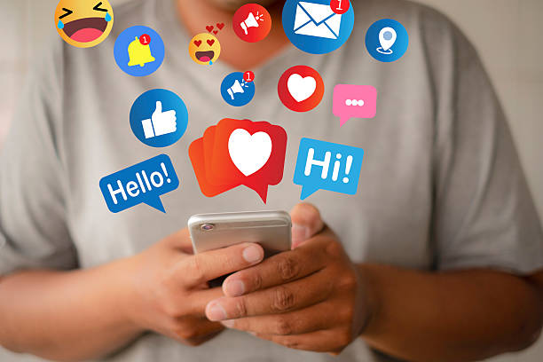 istock Social Media Engagement: Man Using Smartphone with Icons (Like, Emoji, Notification). 2242292760