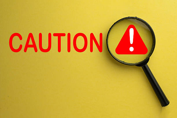 istock Focus on Caution: Risk Assessment and Warning Alert Concept. Yellow background. 2242293347