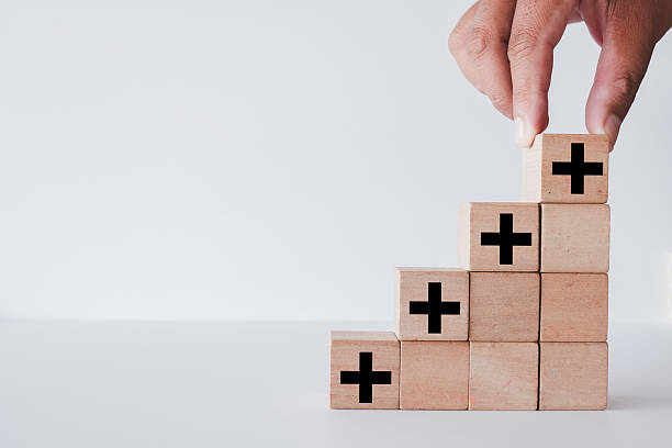 istock Concept of Growth and Added Value: Hand building positive steps. 2242294413