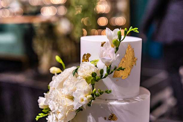 istock Beautiful white wedding cake decorated with flowers close up 2242294686