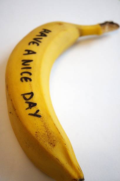 istock Yellow banana with “Have a nice day” text on white background 2242298260