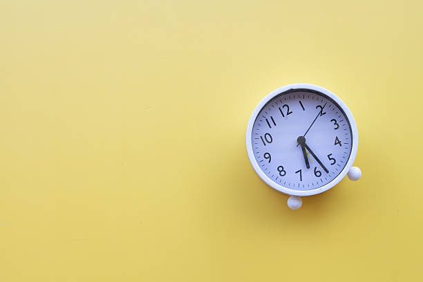 istock Time Management and Deadline Concept: Alarm Clock on Yellow Background 2242307343