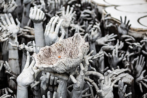 istock Jar with some coins while many hands of a crowd sculpture hang it on on a sculpture 2242307378