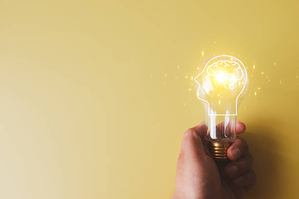 istock Innovation and Creativity Concept: Hand Holding Lightbulb with Brain 2242308070