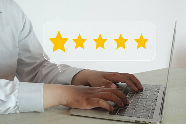 istock Customer Satisfaction: Man Giving 5 Star Rating on Laptop 2242308946