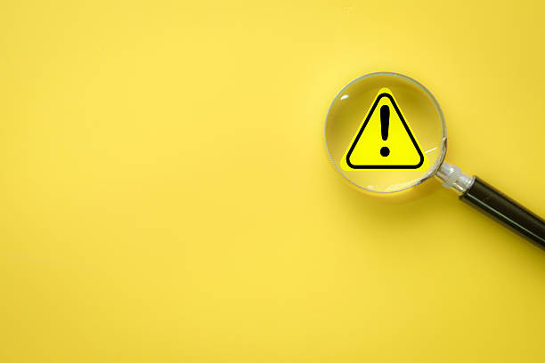 istock Risk Assessment Concept: Magnifier on Warning Alert Icon 2242309089