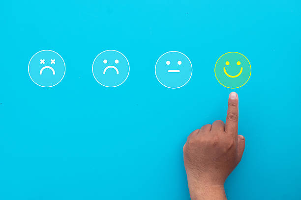 istock Customer Satisfaction: Hand Choosing Happy Face Icon for Feedback 2242310538